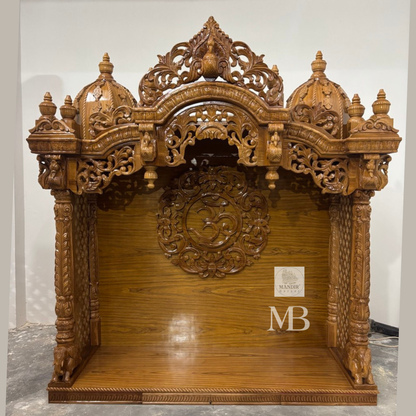 Wooden Hindu temple with carved OM symbol floral details and elephant motifs
