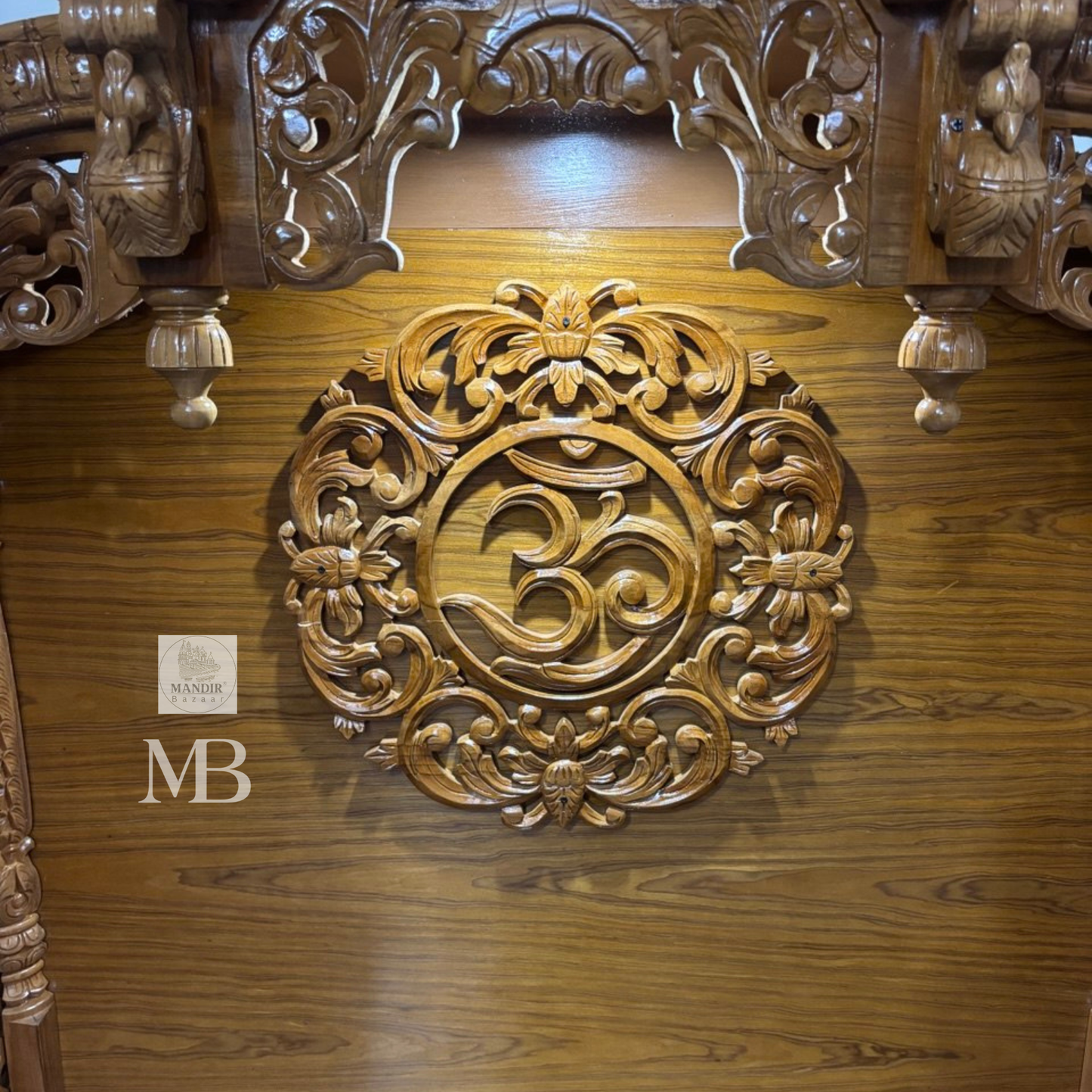 Wooden Hindu temple with carved OM symbol floral details and elephant motifs