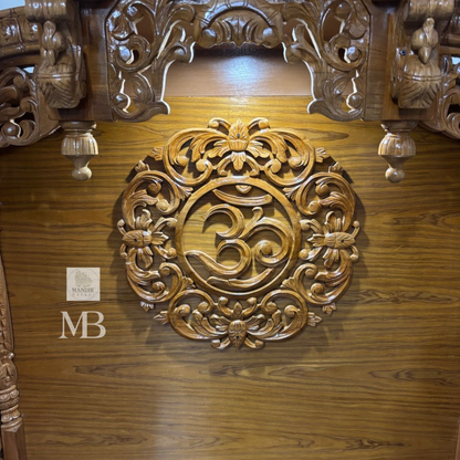 Wooden Hindu temple with carved OM symbol floral details and elephant motifs