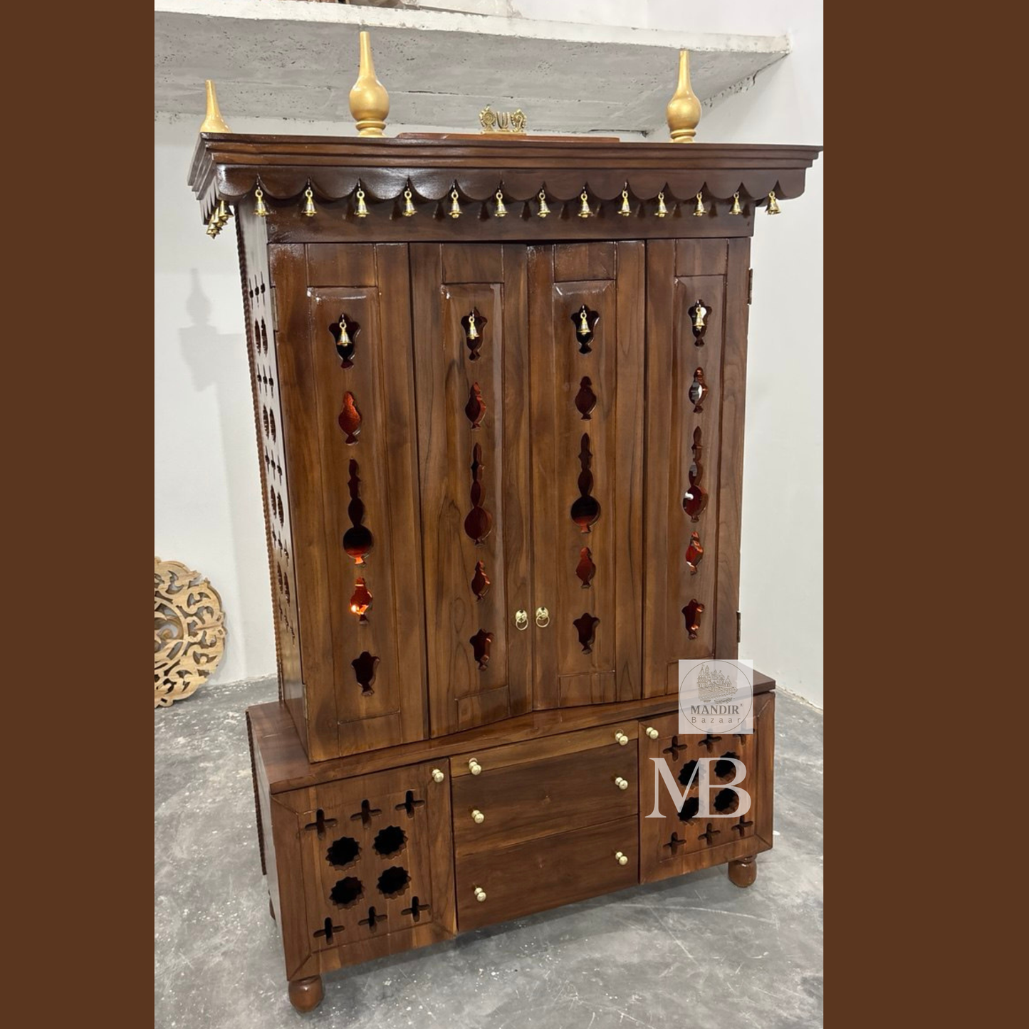 Teak wood home temple with traditional carved canopy and decorative brass hanging bells