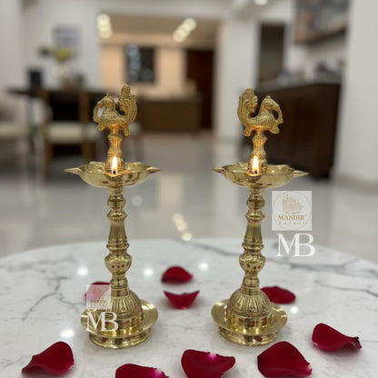 Traditional brass oil lamps with peacock design for pooja