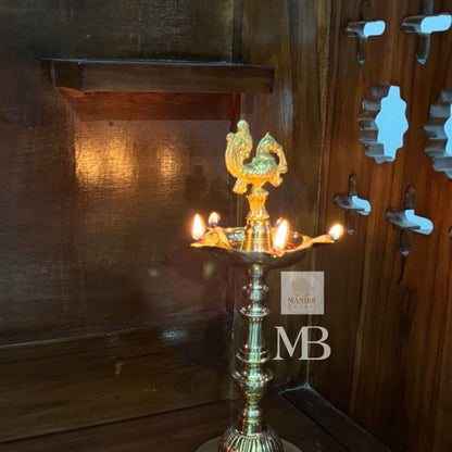 Traditional peacock brass diya for aarti and festivals
