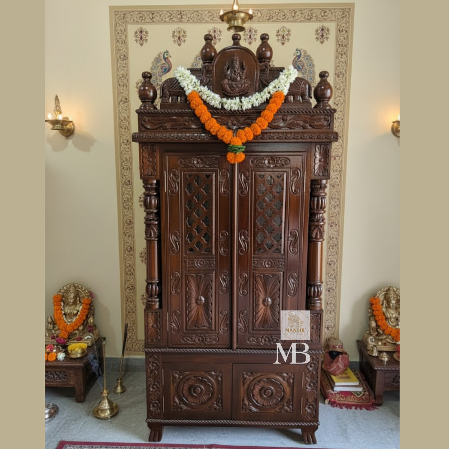 Dark brown hand carved wooden mandir for home with Ganesha carving, jaali doors and storage drawers