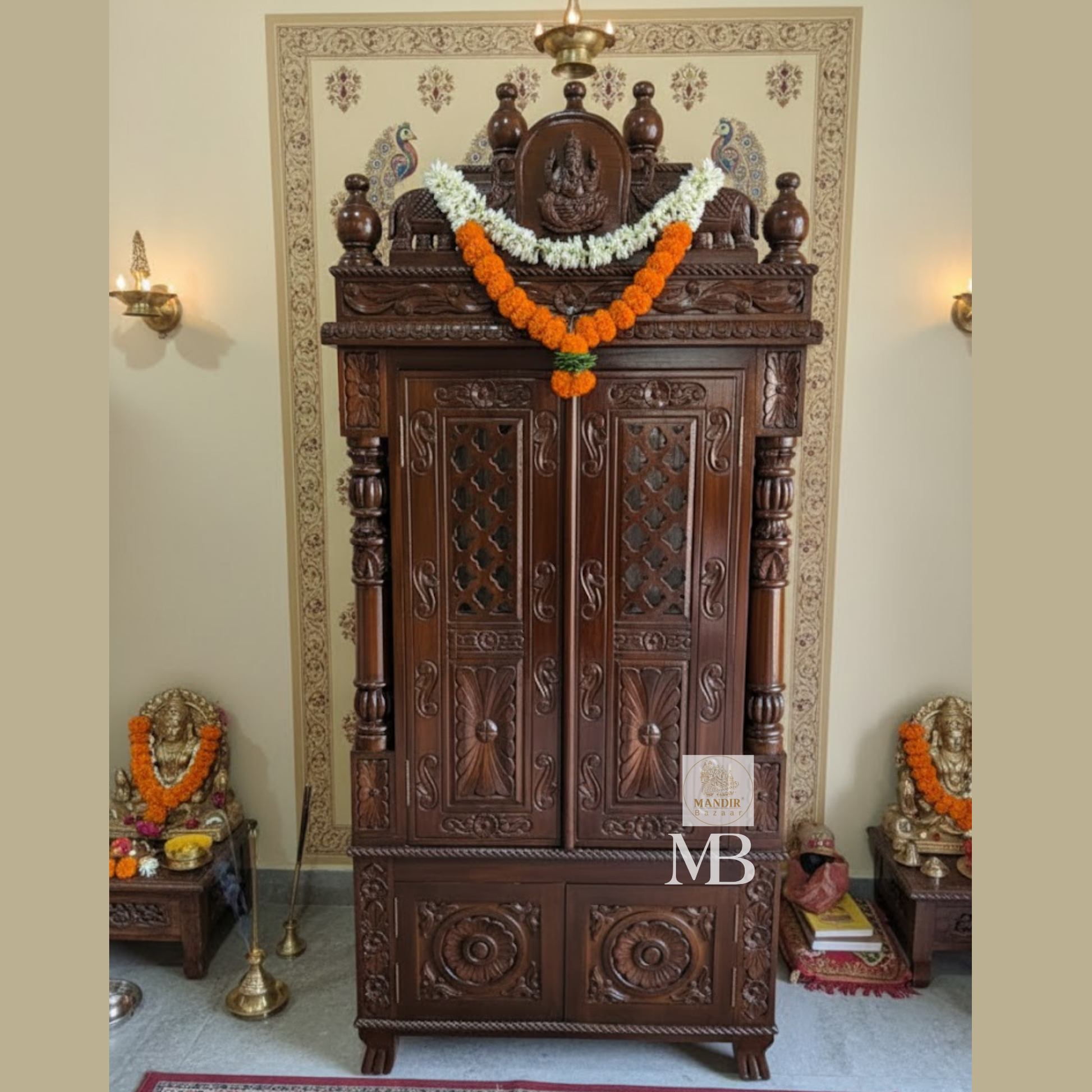 Dark brown hand carved wooden mandir for home with Ganesha carving, jaali doors and storage drawers