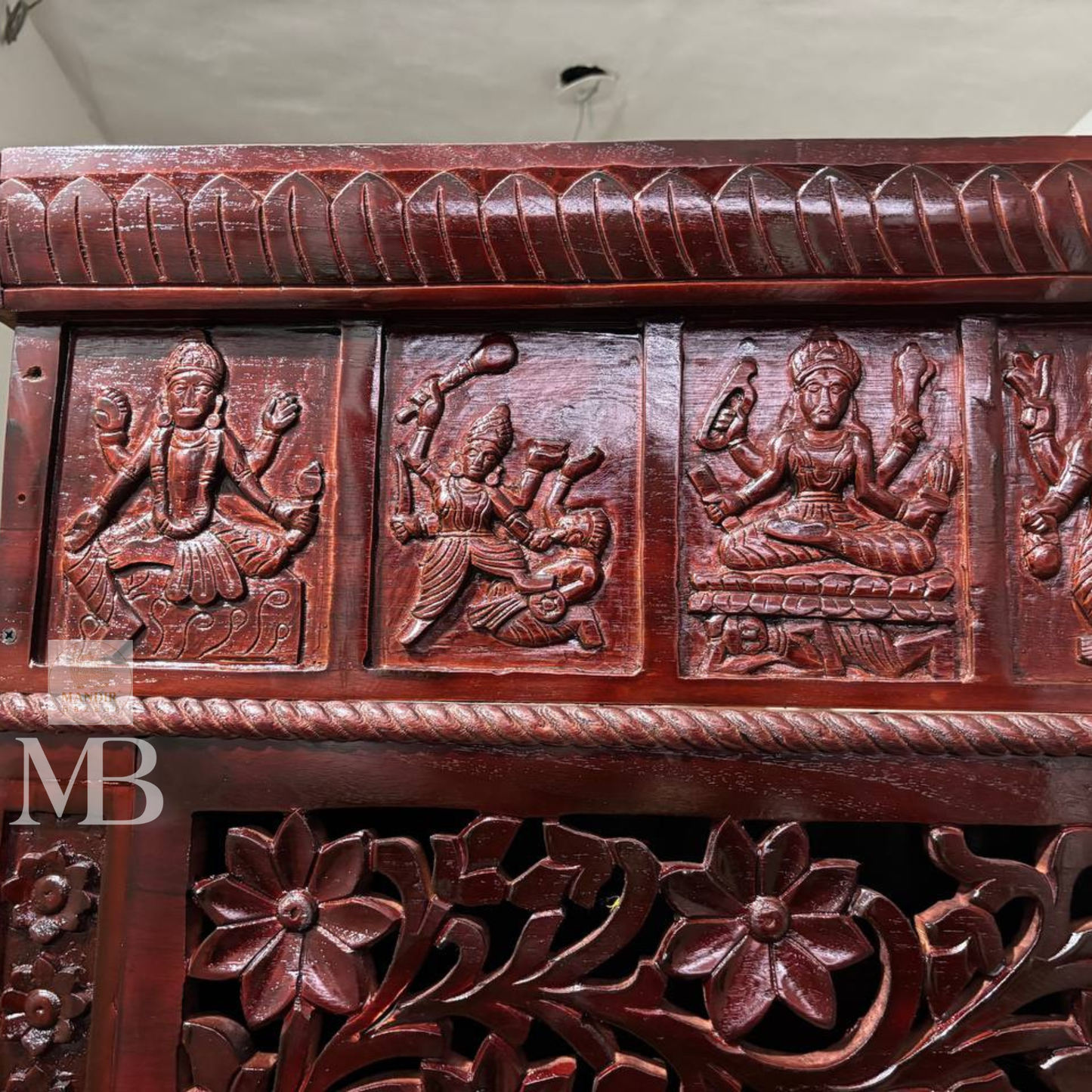 Dark brown wooden pooja mandir with carved floral panels, brass bell accents and spacious storage drawers 7