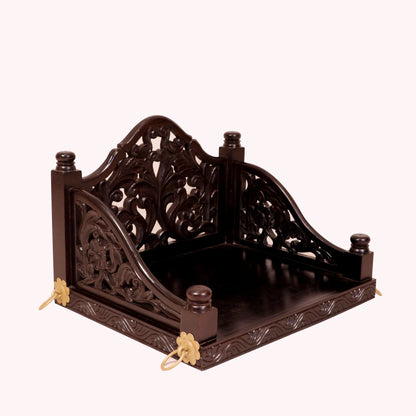 Handcrafted carved detailing on dark tone wooden swing