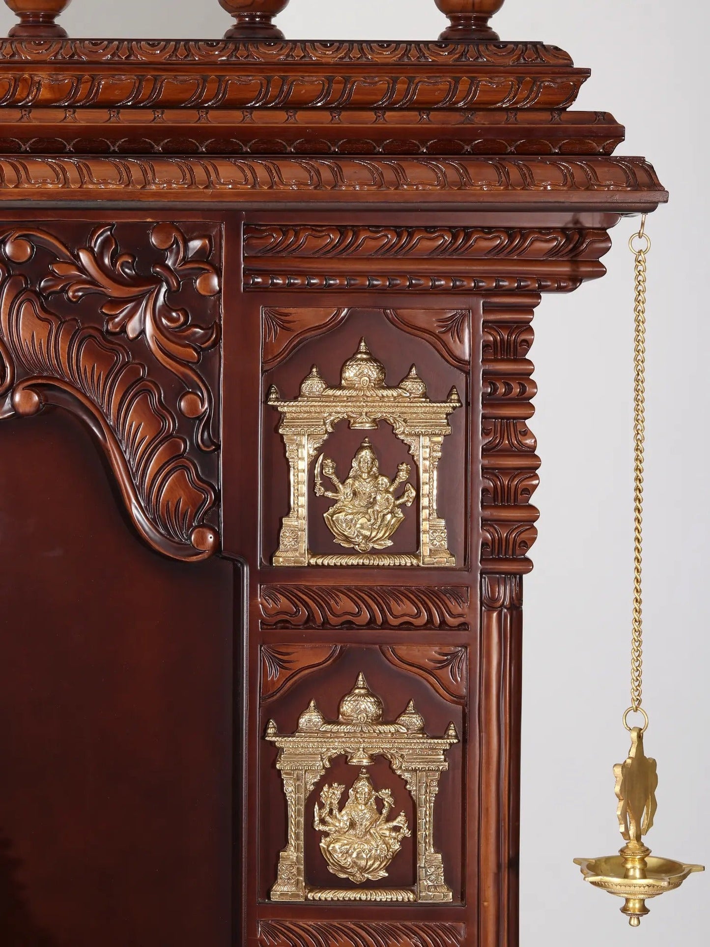 Ashta Lakshmi wooden pooja mandir with decorative brass lamps