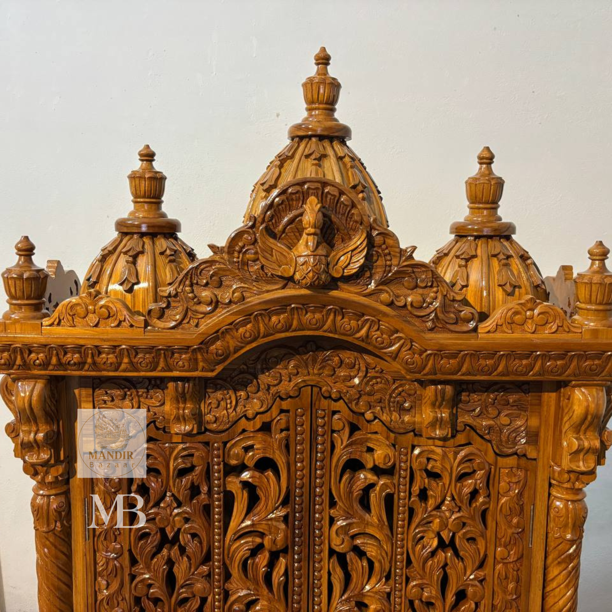 Hand carved wooden mandir for home with traditional shikhar and storage cabinet