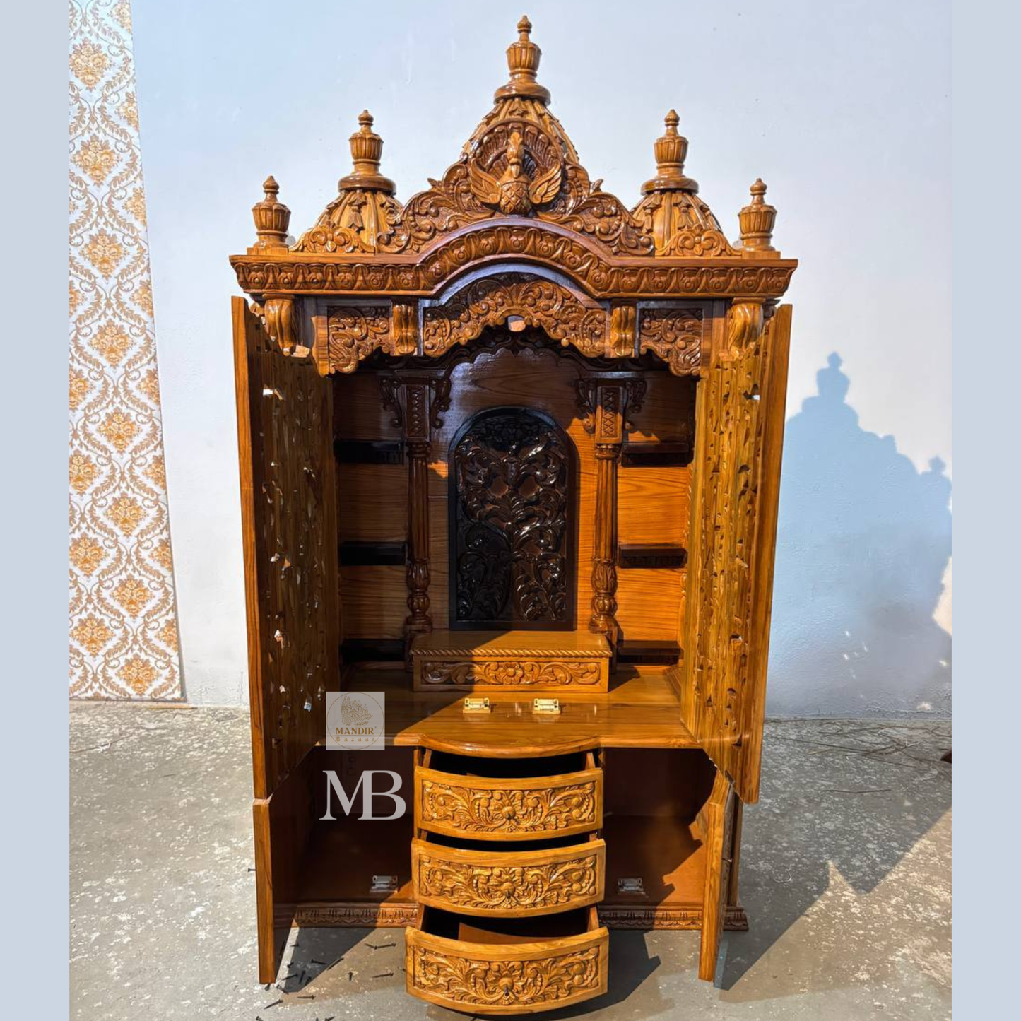 
Hand carved wooden mandir for home with traditional shikhar and storage cabinet