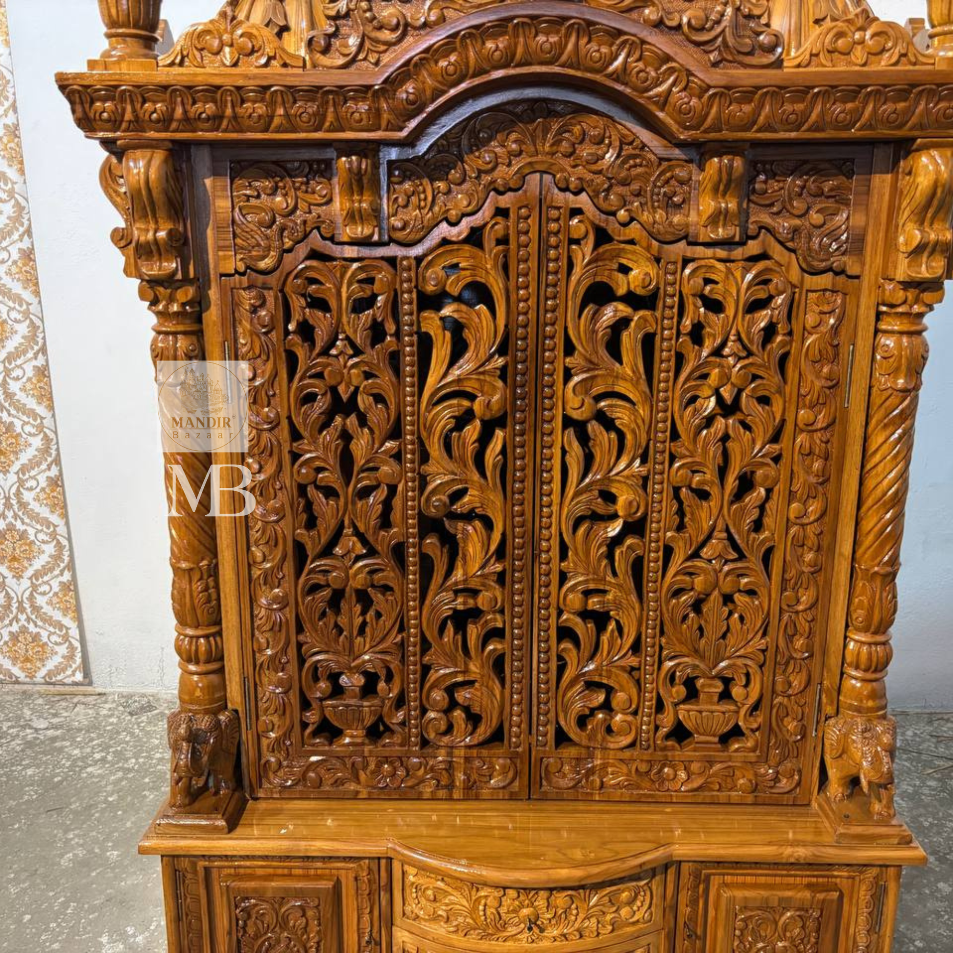 
Hand carved wooden mandir for home with traditional shikhar and storage cabinet