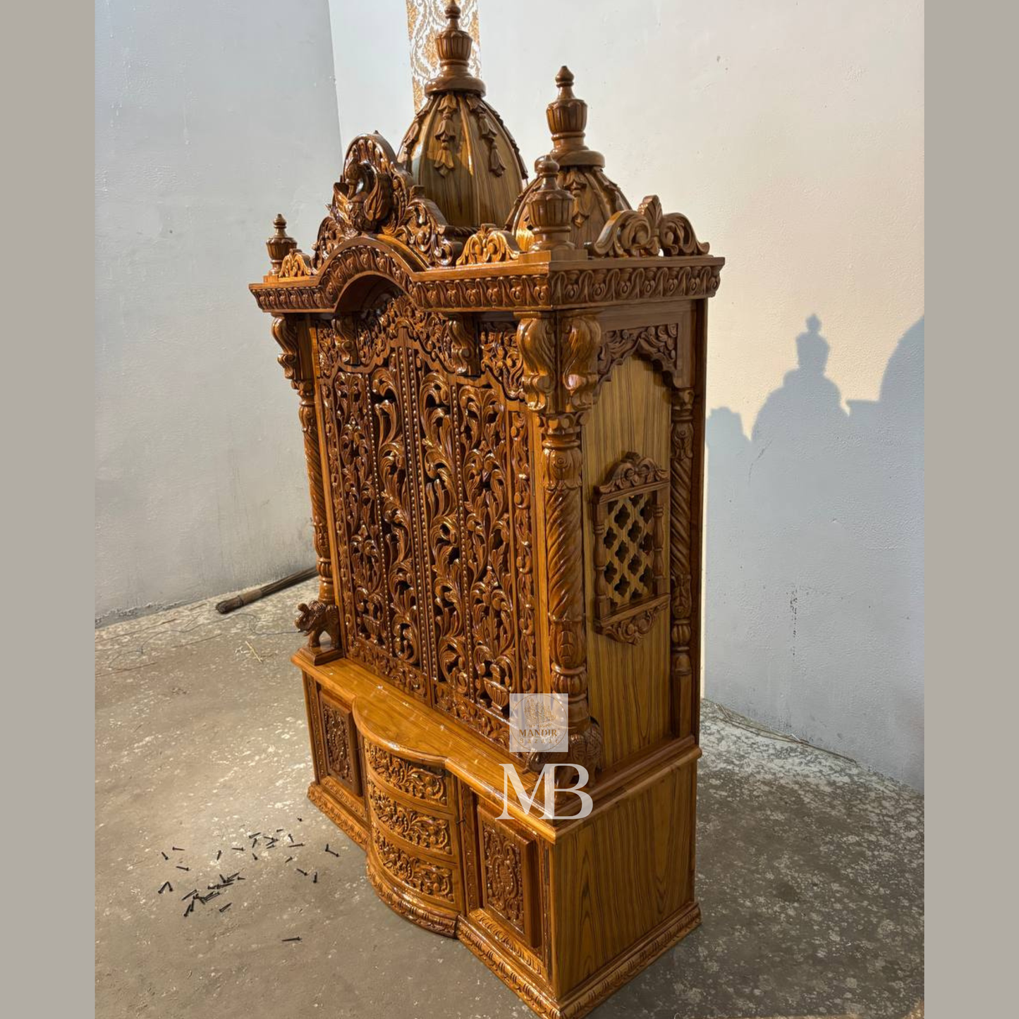 
Hand carved wooden mandir for home with traditional shikhar and storage cabinet