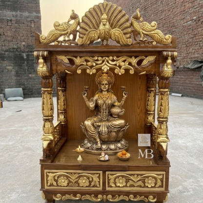 Hand carved wooden pooja mandir in rich brown finish with golden detailing and peacock crown
