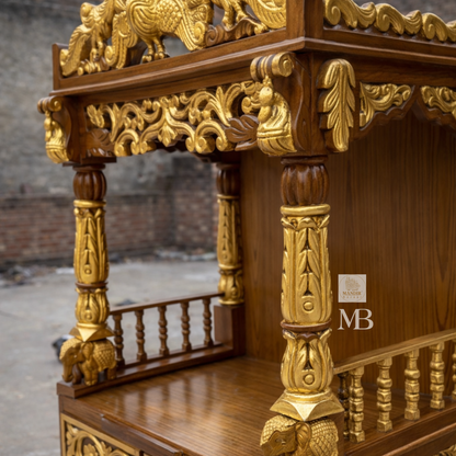 Brown and gold wooden home temple with intricate peacock carving, floral details and carved pillars