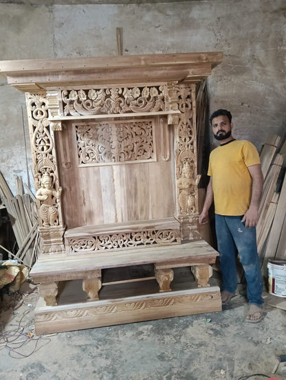 Hand carved wooden pooja mandir with intricate floral carvings, deity figures, marble-look platform and warm LED lights
