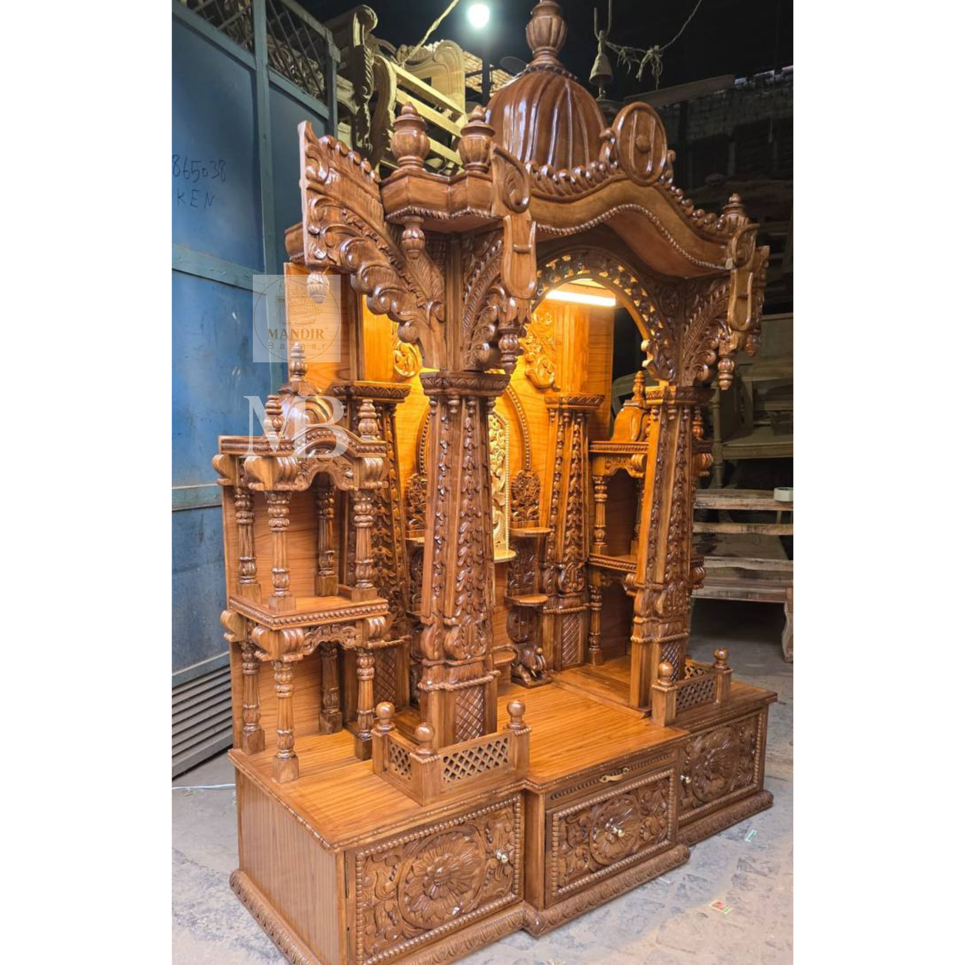 Traditional Indian wooden home temple with decorative arch and carvings