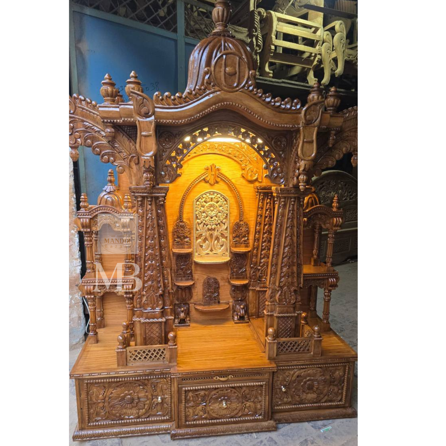 Traditional Indian wooden home temple with decorative arch and carvings