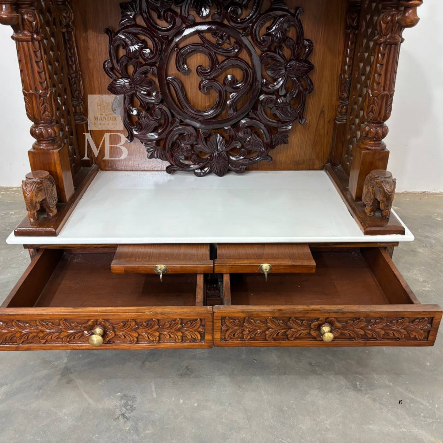 Hand carved wooden pillars and ornamental details on home mandir