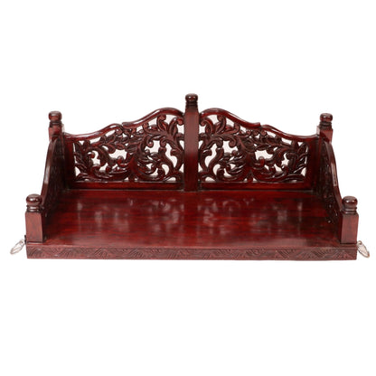 Intricately carved wooden jhula with traditional Indian craftsmanship