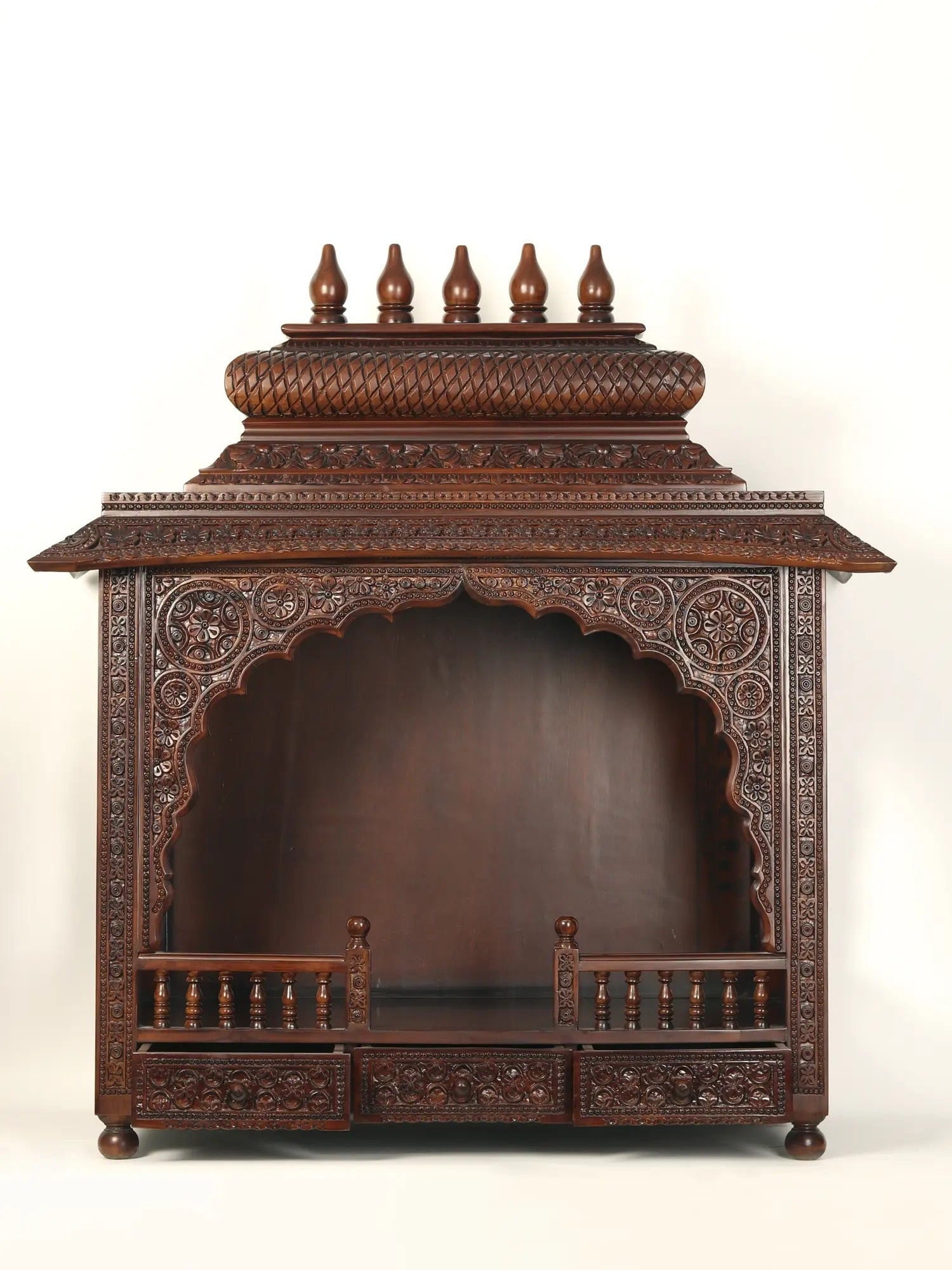 Hand carved wooden pooja mandir with traditional Indian craftsmanship