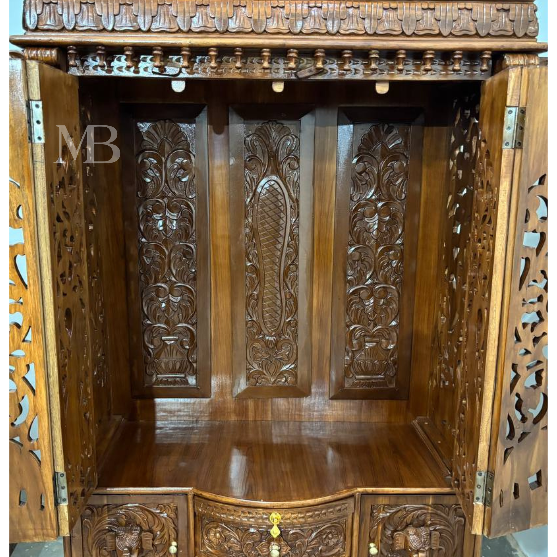 Ornate wooden pooja mandir with traditional temple-style crown