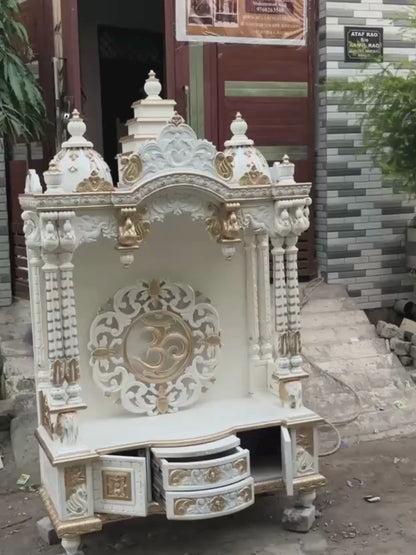 White and gold hand carved wooden mandir for home with Om design and storage cabinet