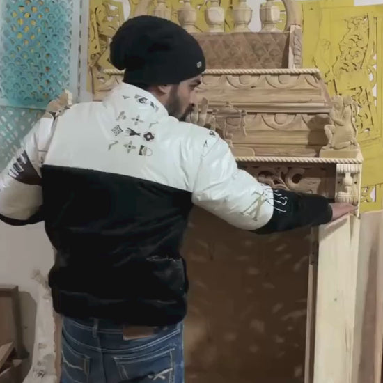 Hand carved wooden pooja mandir doors featuring multiple detailed devotional deity panels