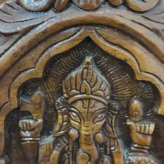 Traditional wooden home temple with carved pillars and decorative deity panels