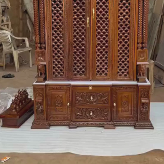 Bottom storage cabinet featuring floral carved drawers and side doors on antique Sheesham wooden temple