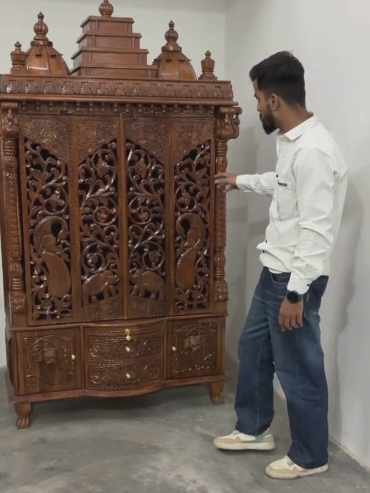Spacious interior of enclosed wooden pooja mandir for home prayer