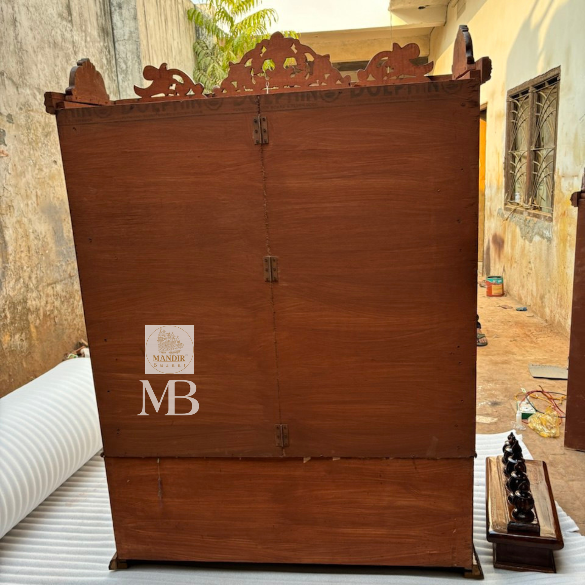 Bottom storage cabinet featuring floral carved drawers and side doors on antique Sheesham wooden temple
