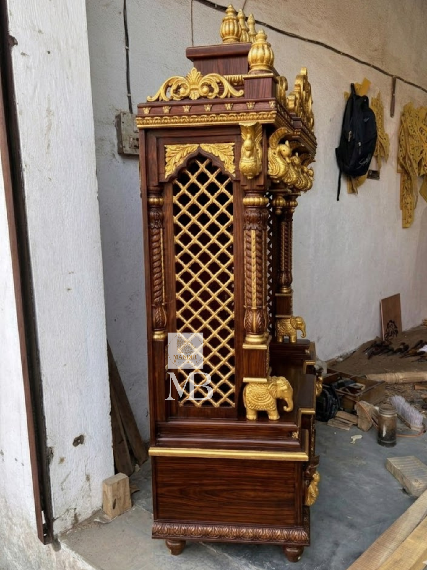 6 feet tall open front Sheesham wood home temple with red velvet backing and gold elephant pillars