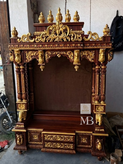 Detailed close up of golden kalash finials and hand-carved floral arch crown on dark wood temple