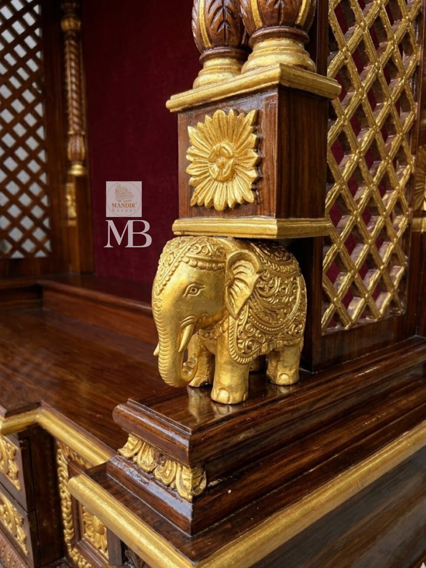 Gold highlighted floral carved storage drawers at the base of Sheesham wood pooja mandir