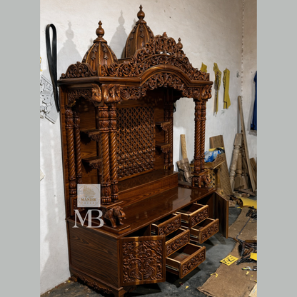 Hand carved Sheesham wood pooja mandir in walnut brown finish with storage drawers and decorative pillars