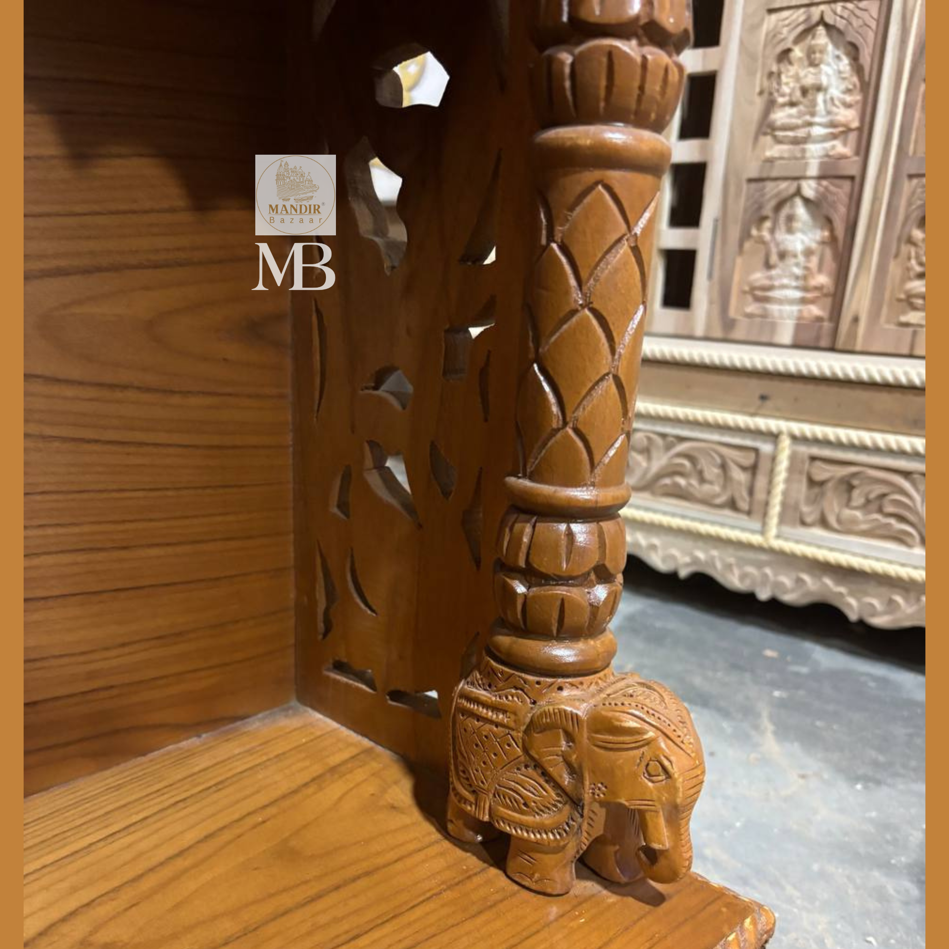 Close up detail of carved elephant pillar base and floral bottom drawer on Sheesham wood tabletop mandir