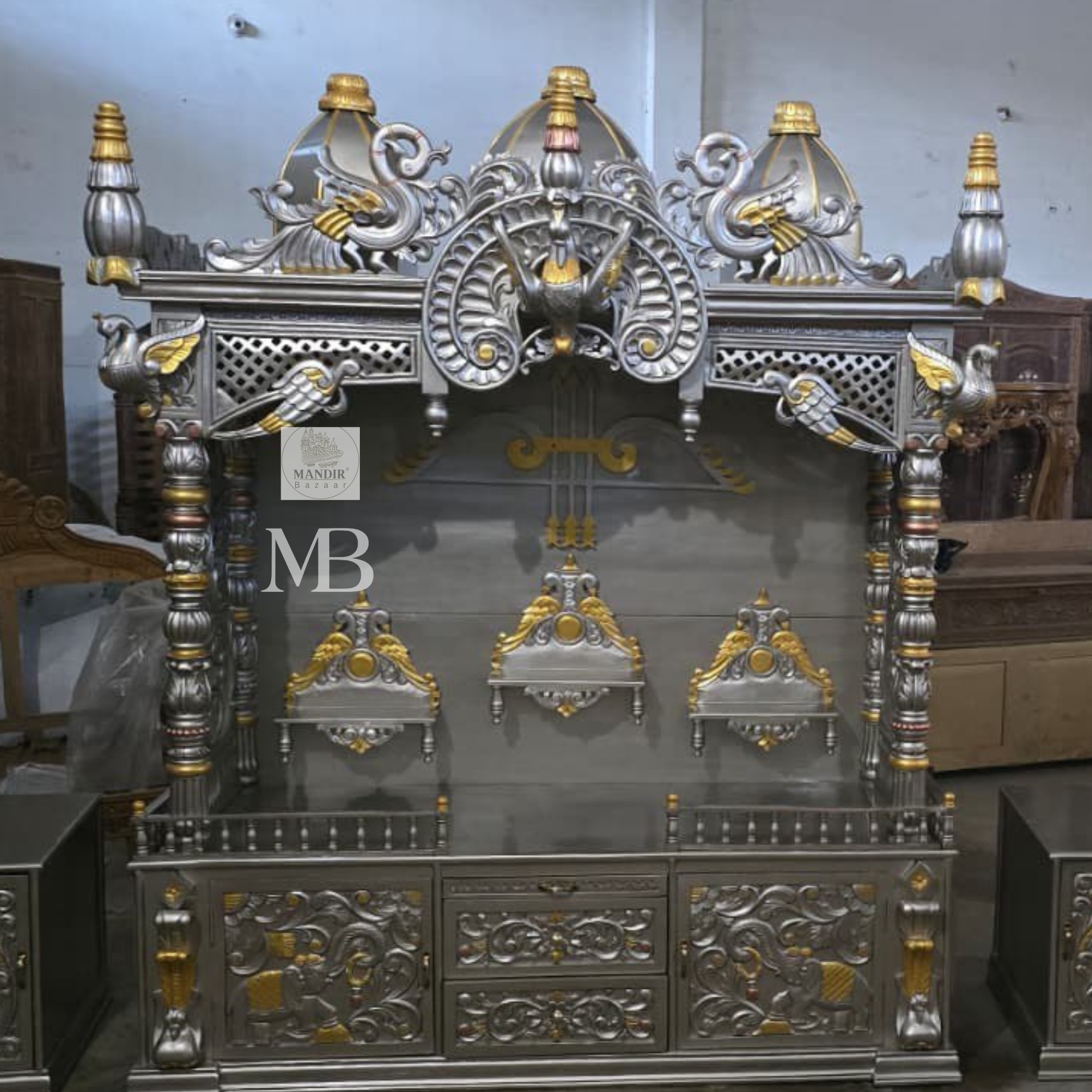 Luxury silver and gold hand carved wooden pooja mandir with ornate crown, decorative pillars, storage drawers and matching side cabinets
