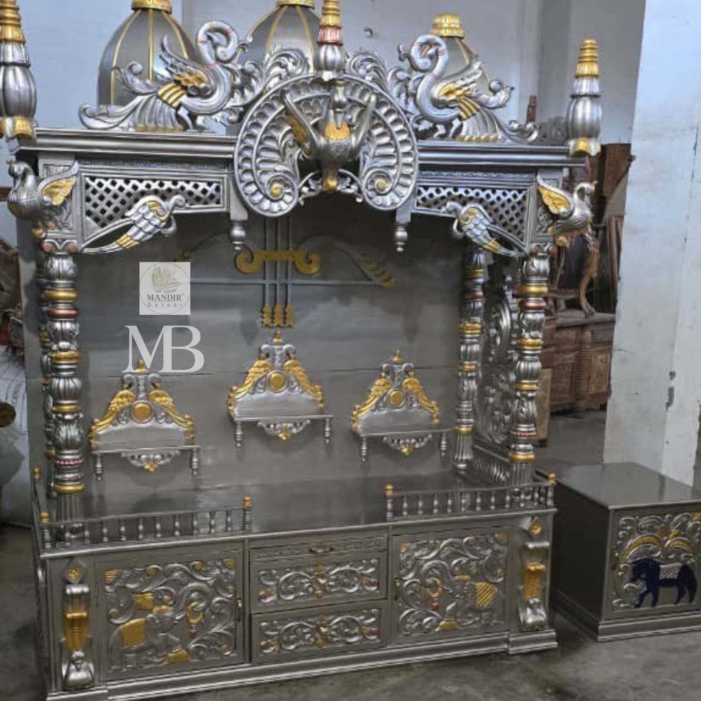 Luxury silver and gold hand carved wooden pooja mandir with ornate crown, decorative pillars, storage drawers and matching side cabinets