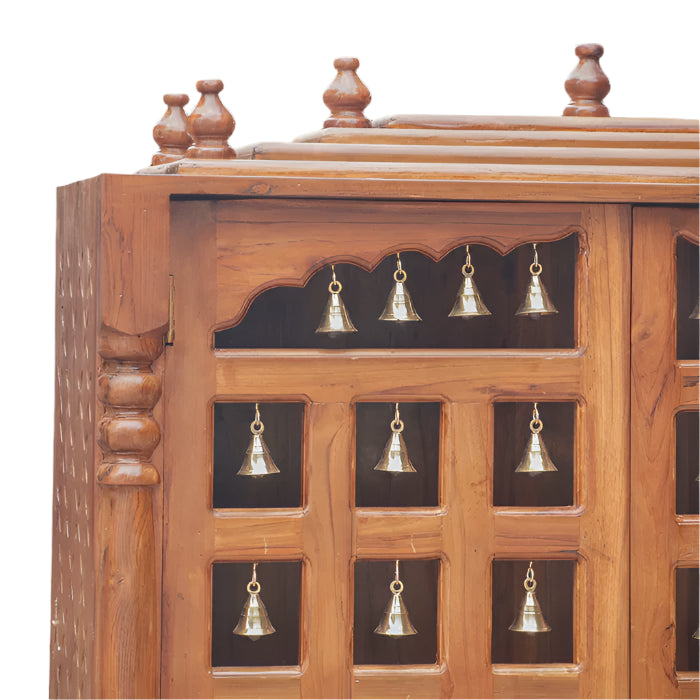 Teak wood temple with traditional brass bell doors