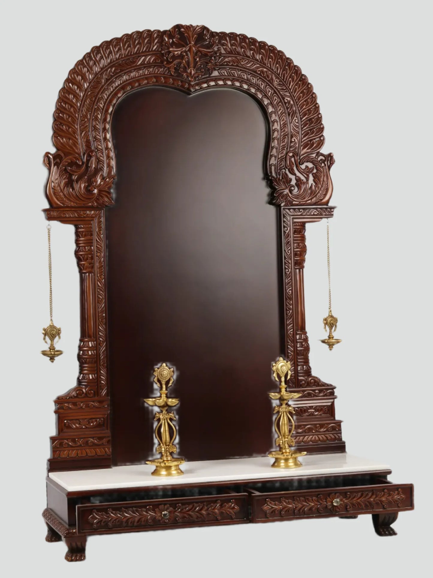 Large wooden Hindu temple frame with traditional brass lamps