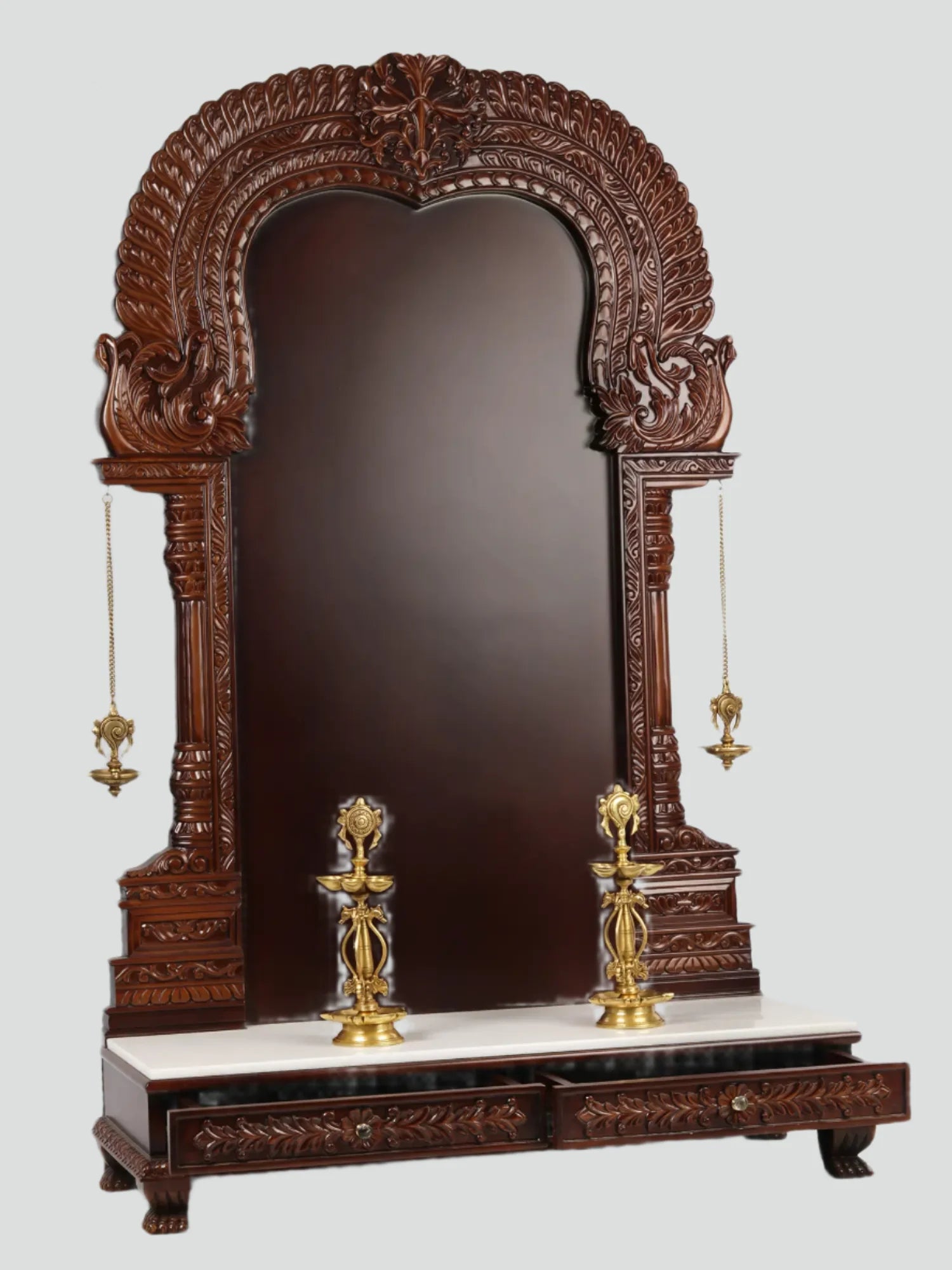 Large wooden Hindu temple frame with traditional brass lamps