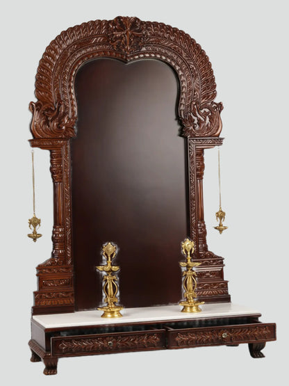 Large wooden Hindu temple frame with traditional brass lamps
