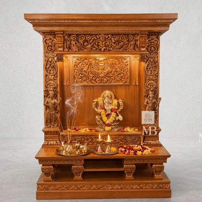 Traditional wooden pooja mandir for home with ornate pillars and decorative floral detailing