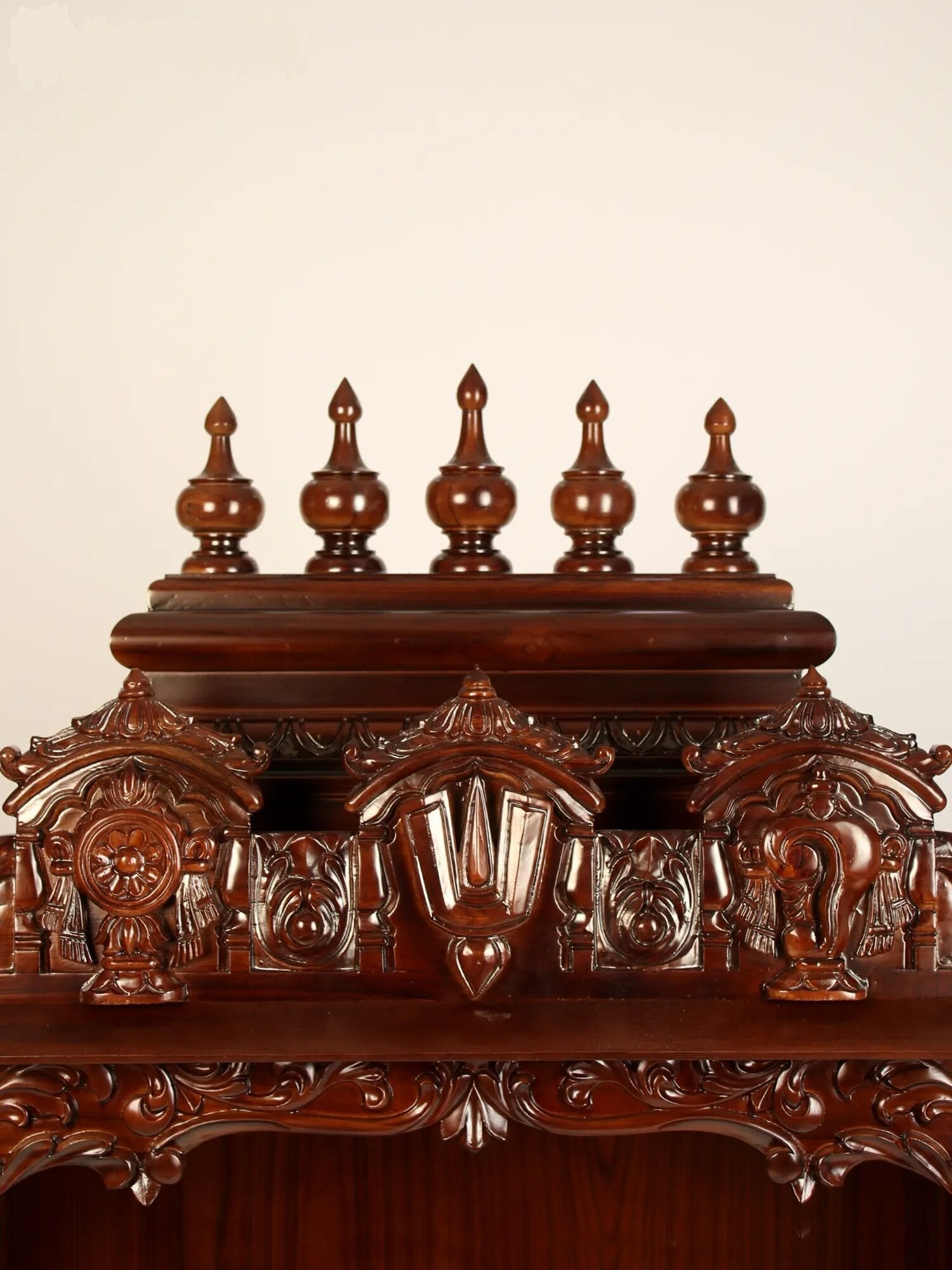 Hand carved wooden Hindu temple with Vaishnava symbols