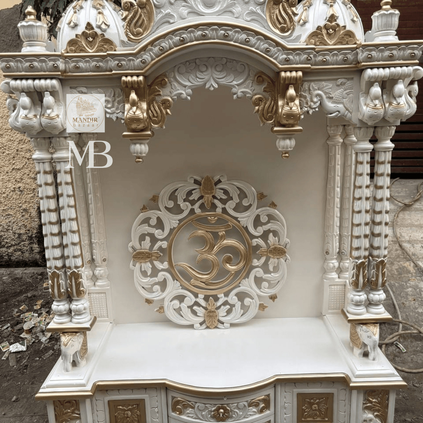 White and gold hand carved wooden mandir for home with Om design and storage cabinet