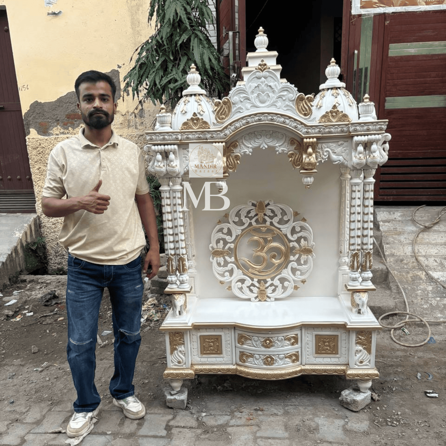 White and gold hand carved wooden mandir for home with Om design and storage cabinet