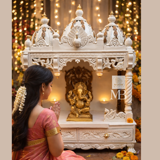 Handcrafted white wooden home temple with gold carved highlights and triple peacock domes