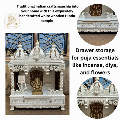 Hand carved golden tree back panel with idol step shelves inside white wooden home mandir