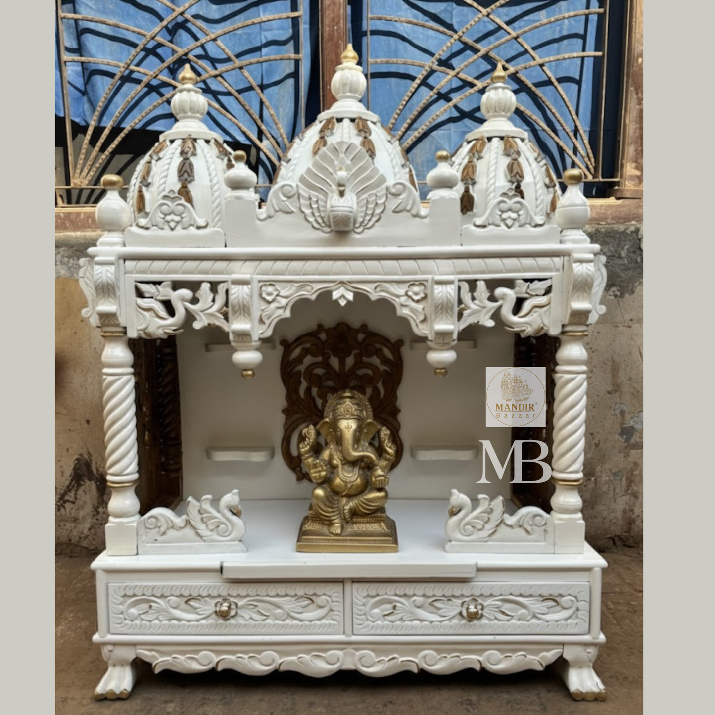 Detailed carved swan motifs and storage drawers with floral patterns on white wooden temple