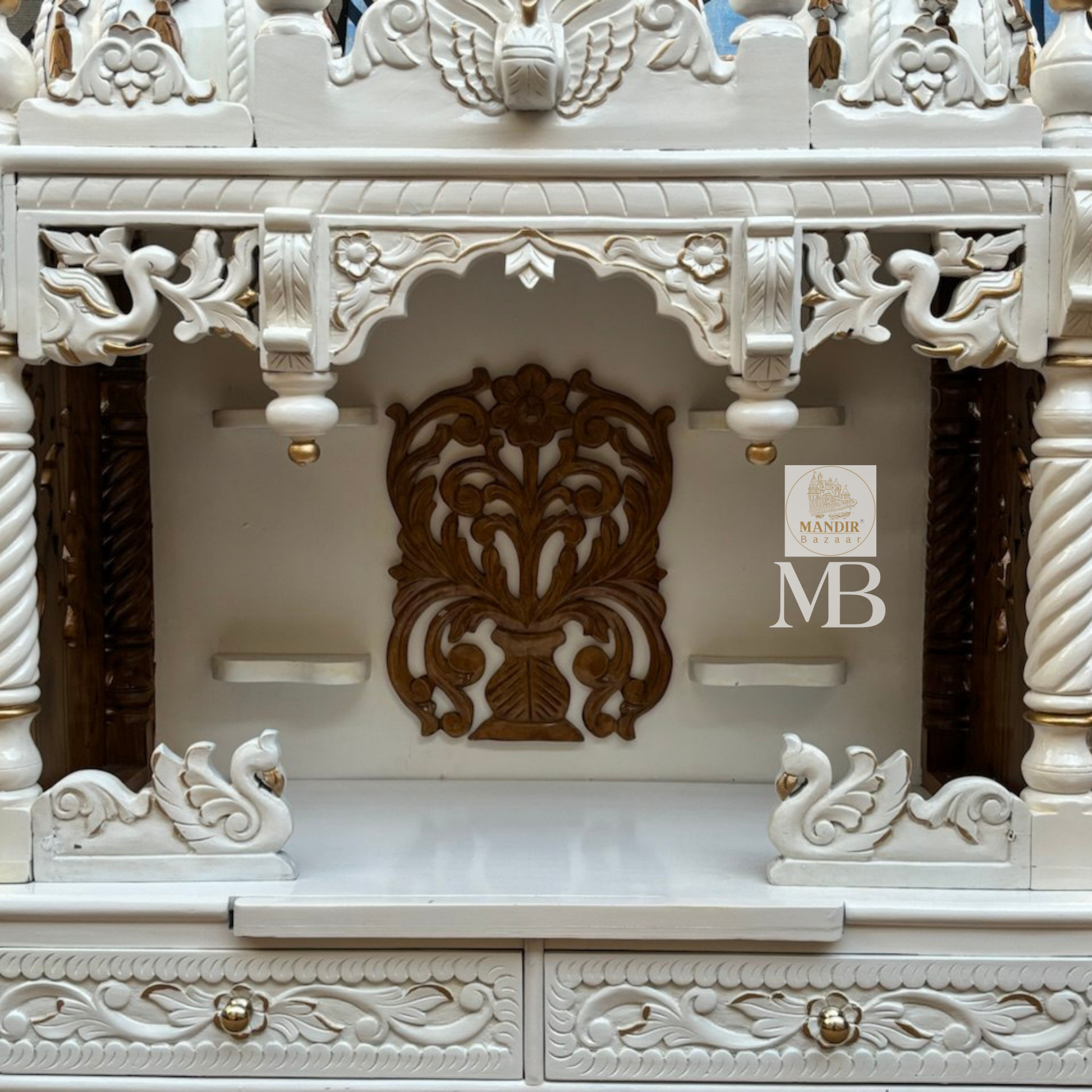 Handcrafted white wooden home temple with gold carved highlights and triple peacock domes