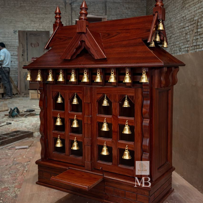 Side angle perspective view of mahogany finish Sheesham wood temple showing roof gables and kalash finials